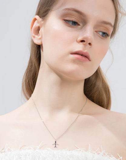 airplane necklace in silver worn by a woman